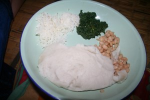 A good meal; nsima, rice, beans, and pumpkin leaves.