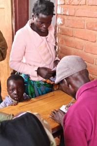 Neveson checks in a patient.